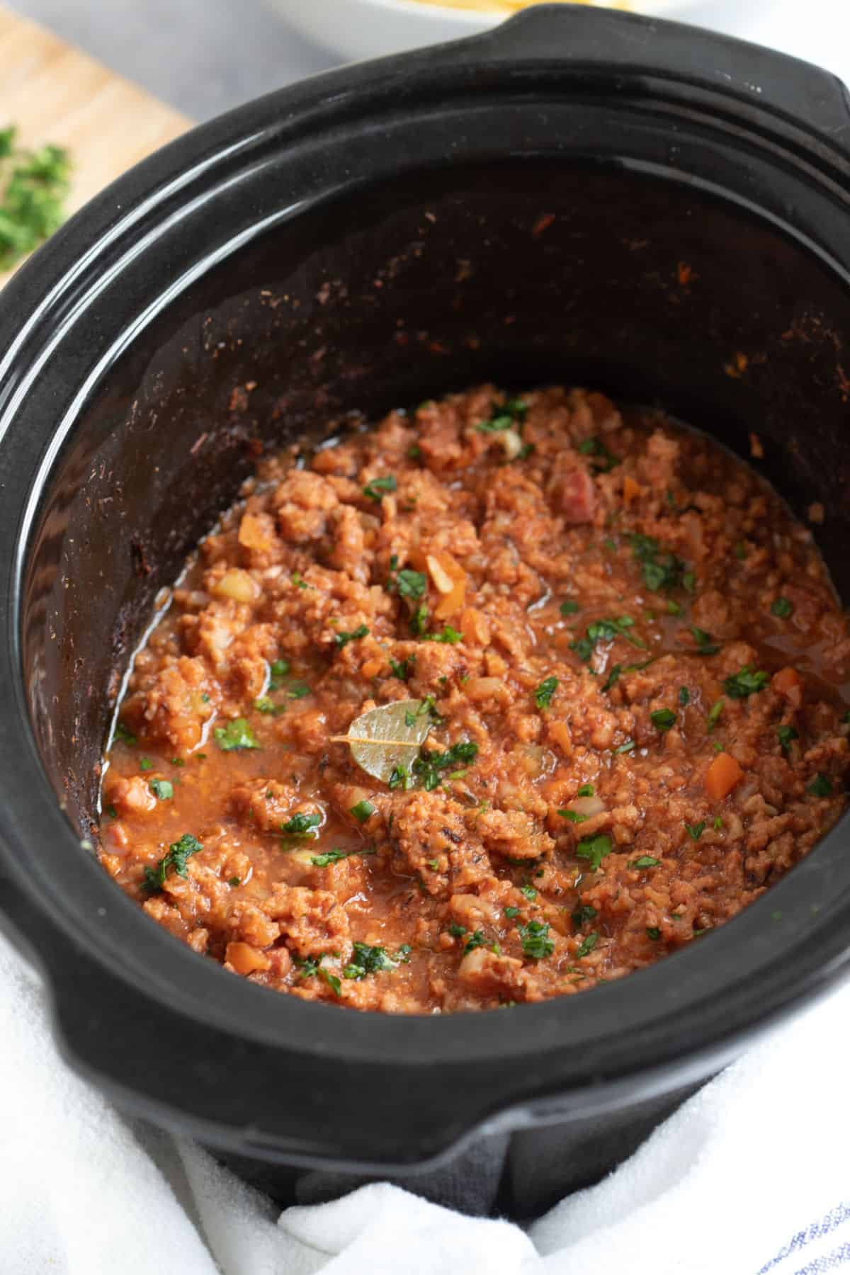 Slow cooker pork mince ragu in a slow cooker.