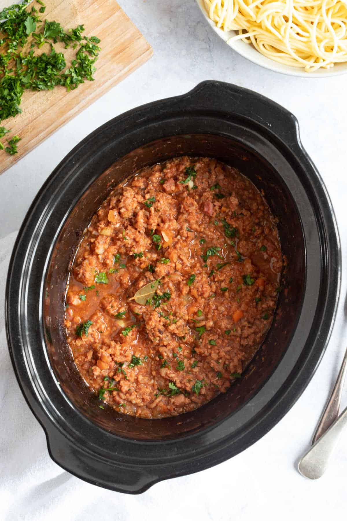 Slow cooker pork mince ragu garnish with parsley.