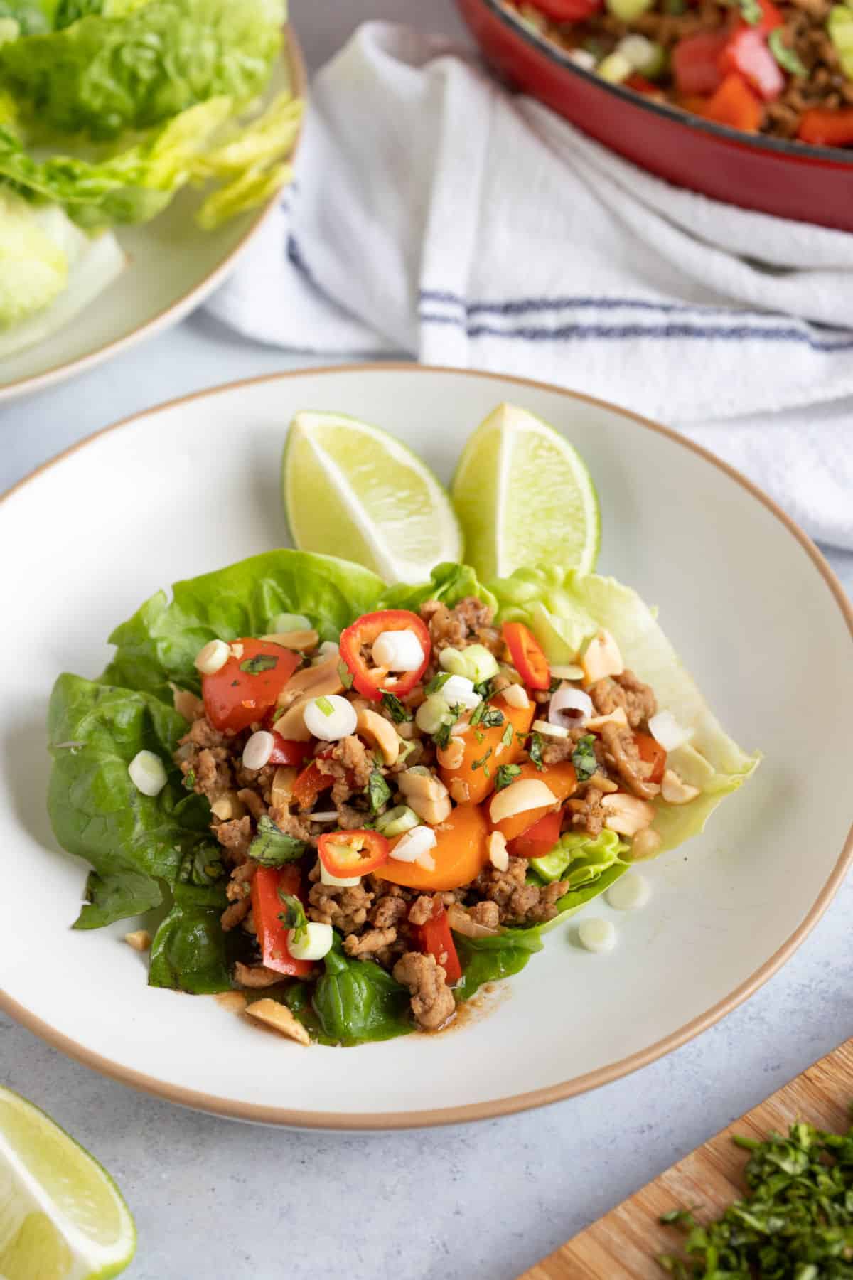 Chinese lettuce wraps on a plate filled with stir-fried pork mince.