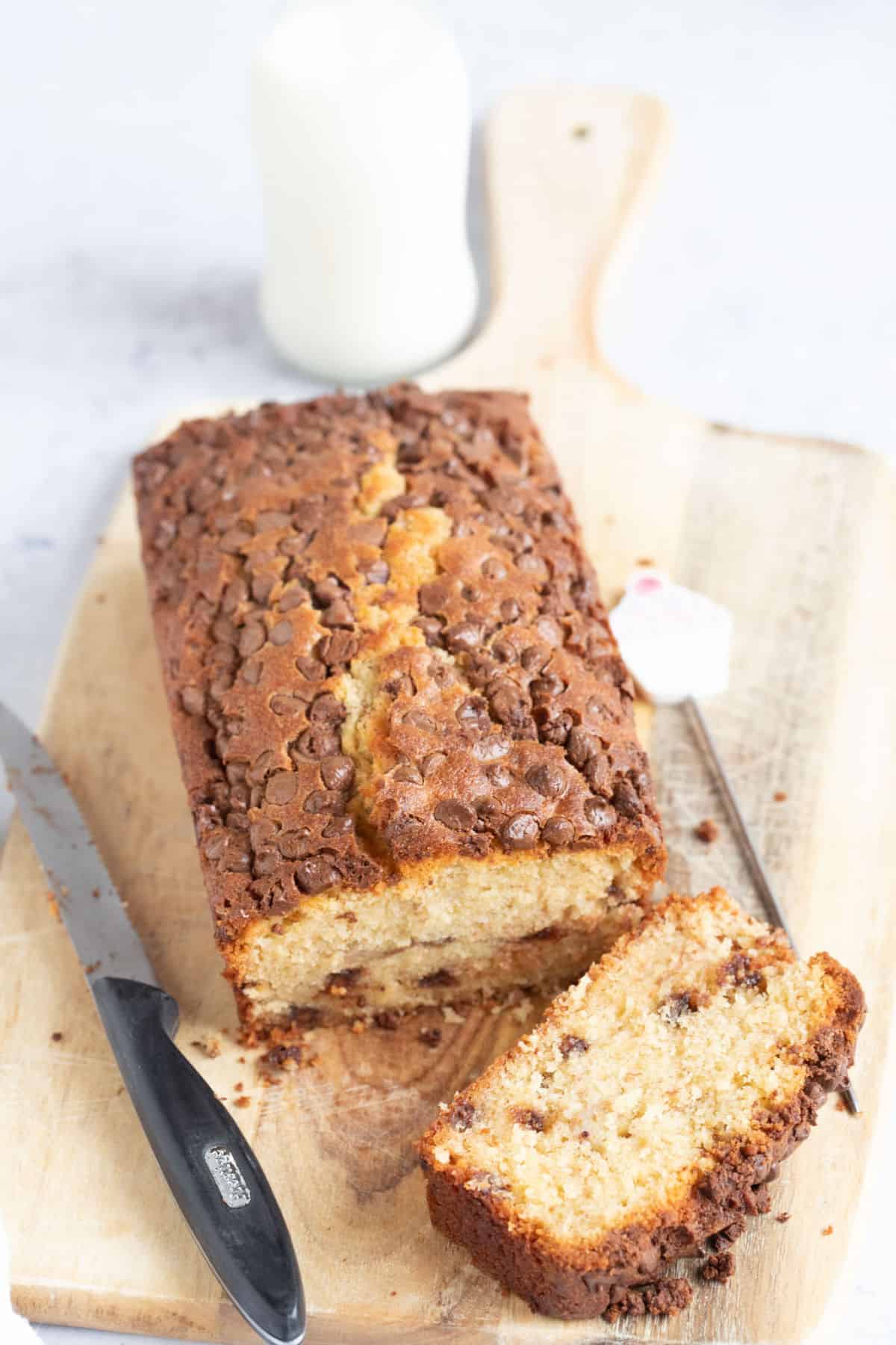 Air fryer banana bread with milk chocolate chips on a wooden board.