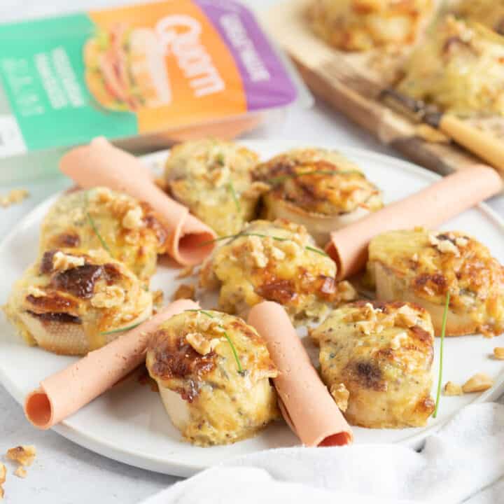 Quorn ham and stilton rarebit bites on a white platter.