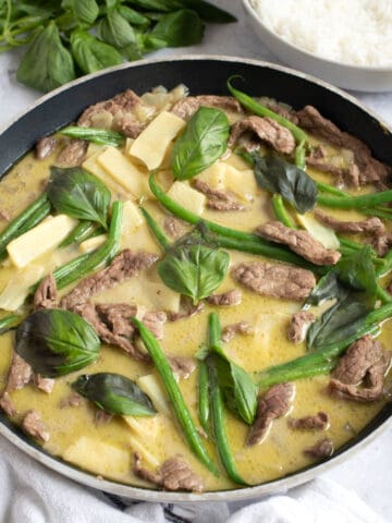 Thai green beef curry in a wok.