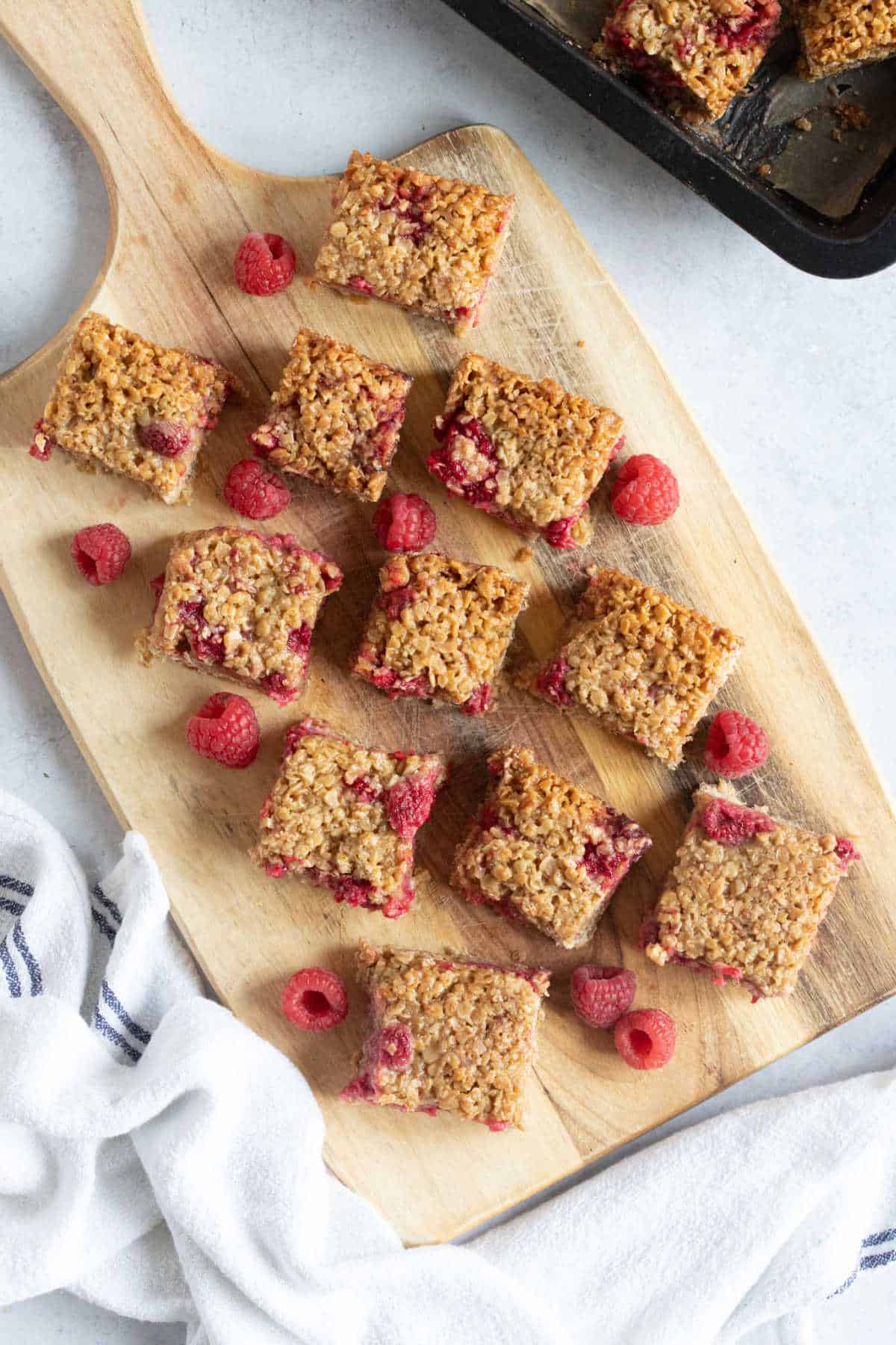 Raspberry Oat Bars on a serving board.