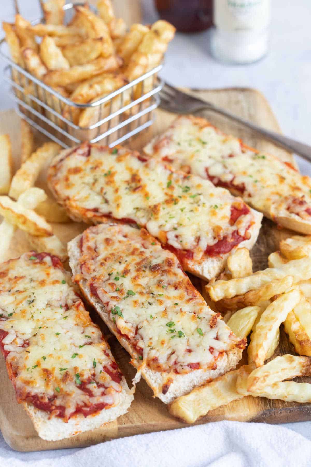 Slices of air fryer cheese and tomato pizza with air fryer chips.