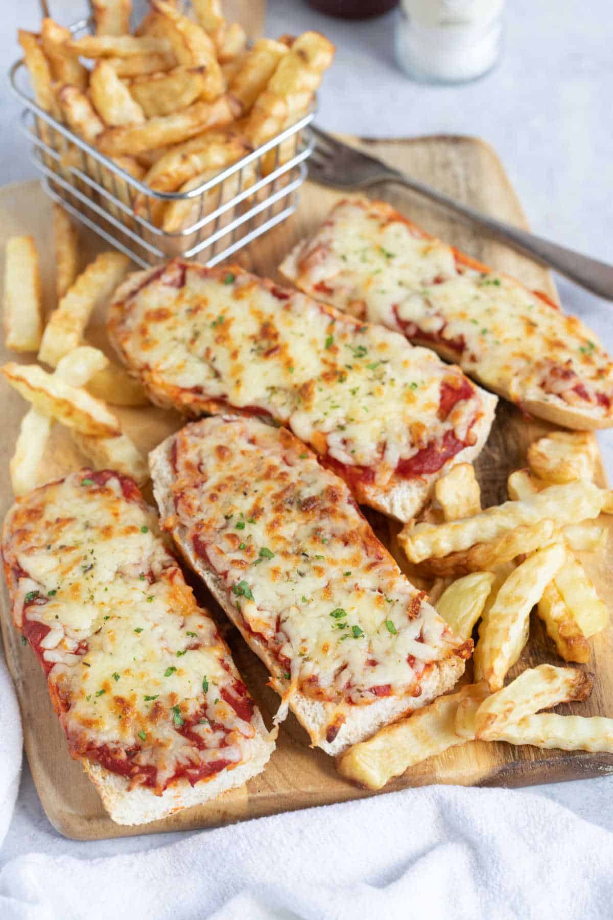 Slices of air fryer French bread pizza with air fryer chips.