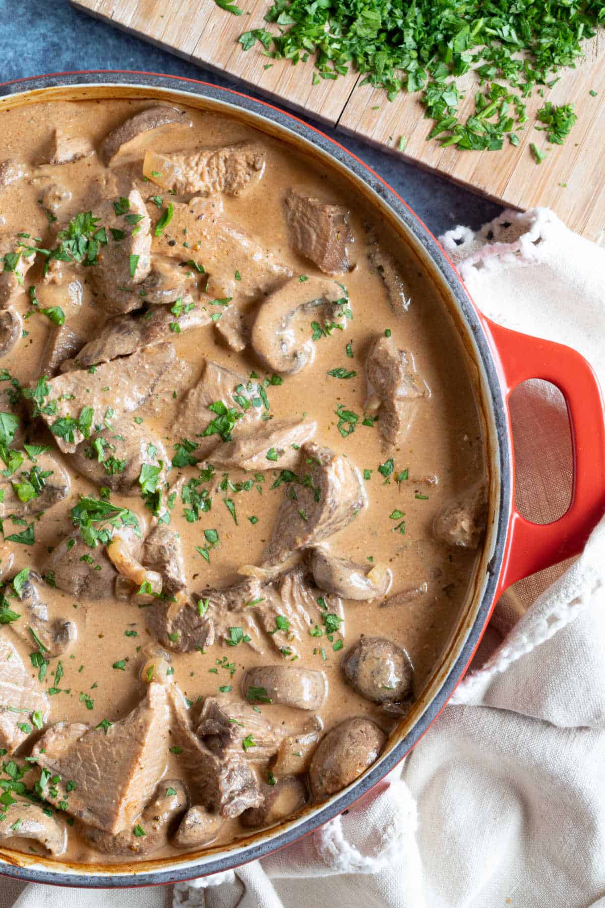 Leftover roast beef stroganoff in a red pan.