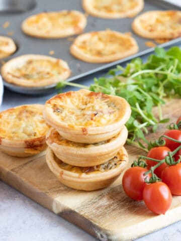 A stack of mini ham and cheese quiches.