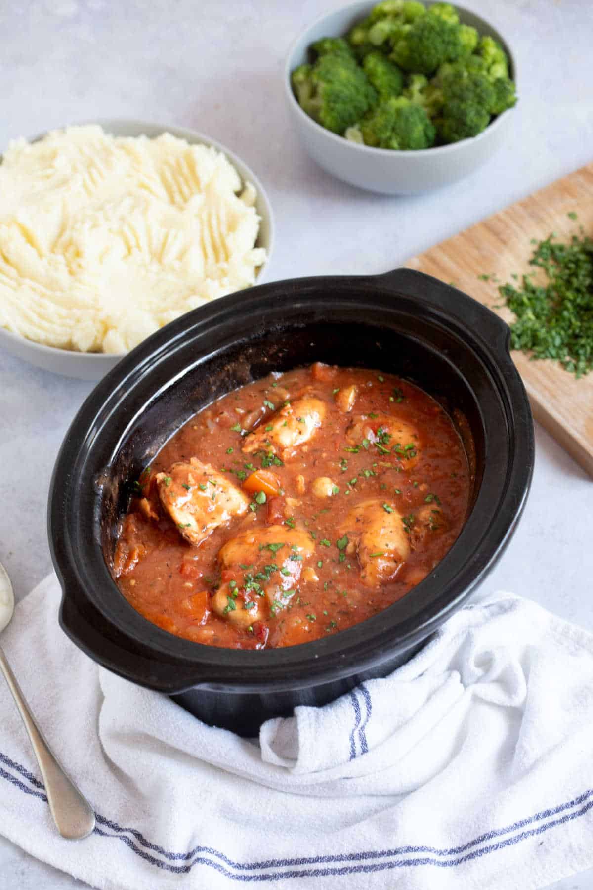 Slow cooker chicken chasseur in a slow cooker basin.