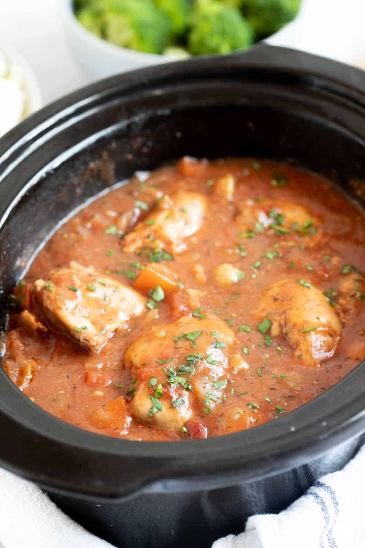 Chicken chasseur in a slow cooker basin.