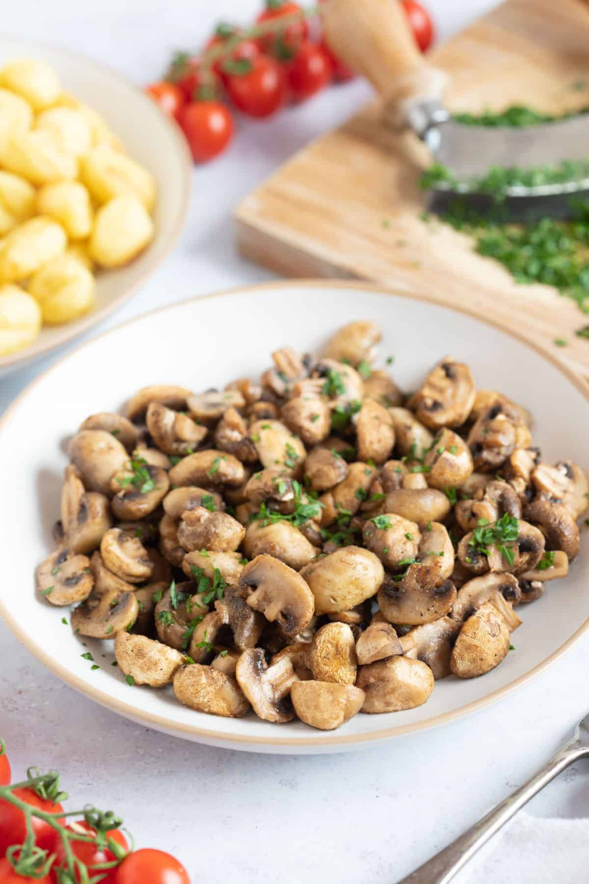A plate of air fryer garlic mushrooms with parsley.