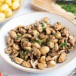 Golden brown air fryer garlic mushrooms on a plate.