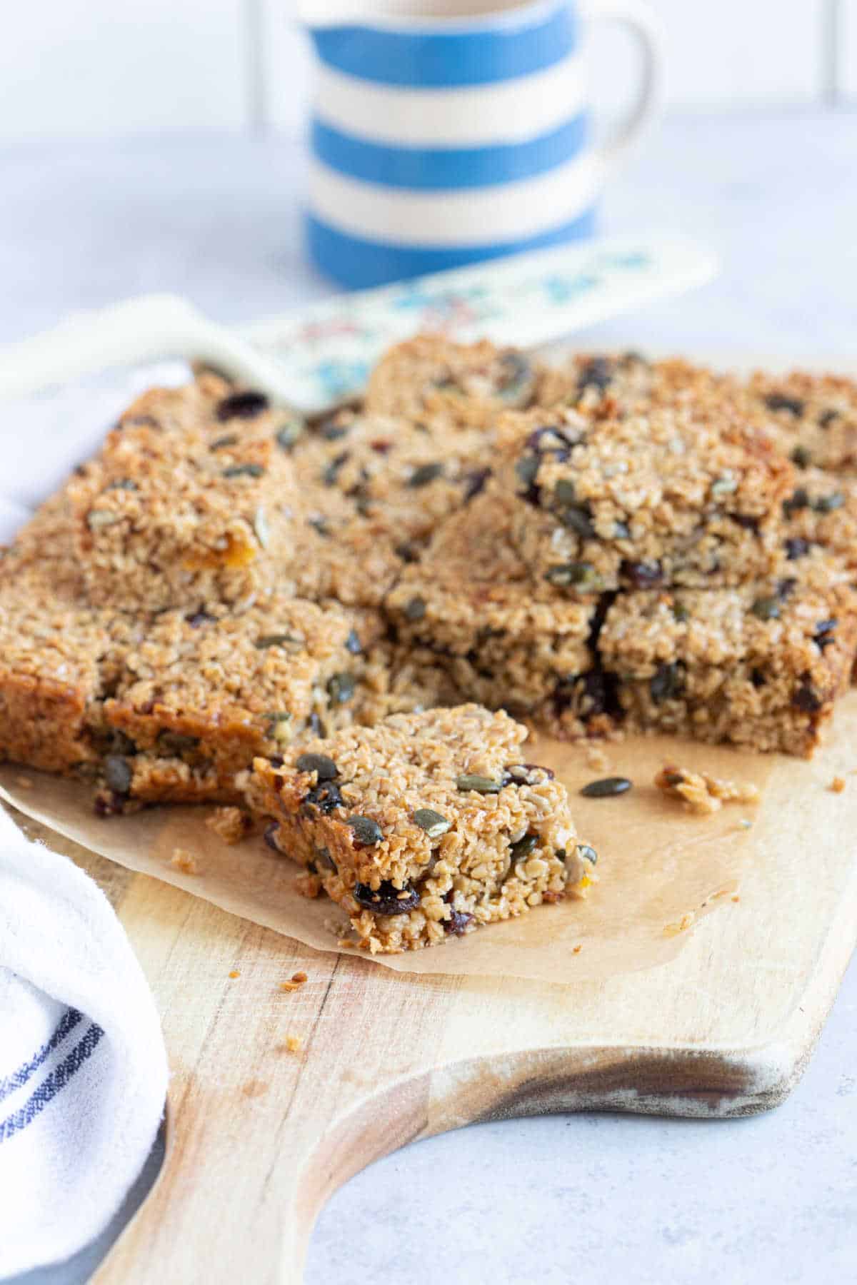 Granola bars on a wooden board.