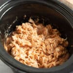 BBQ pulled chicken in a slow cooker.