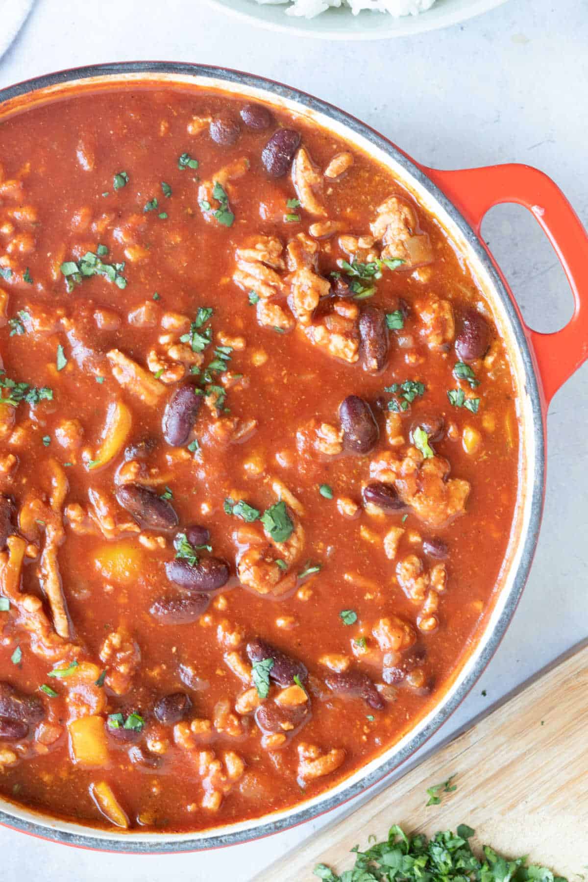 Turkey mince chilli in a red pan.