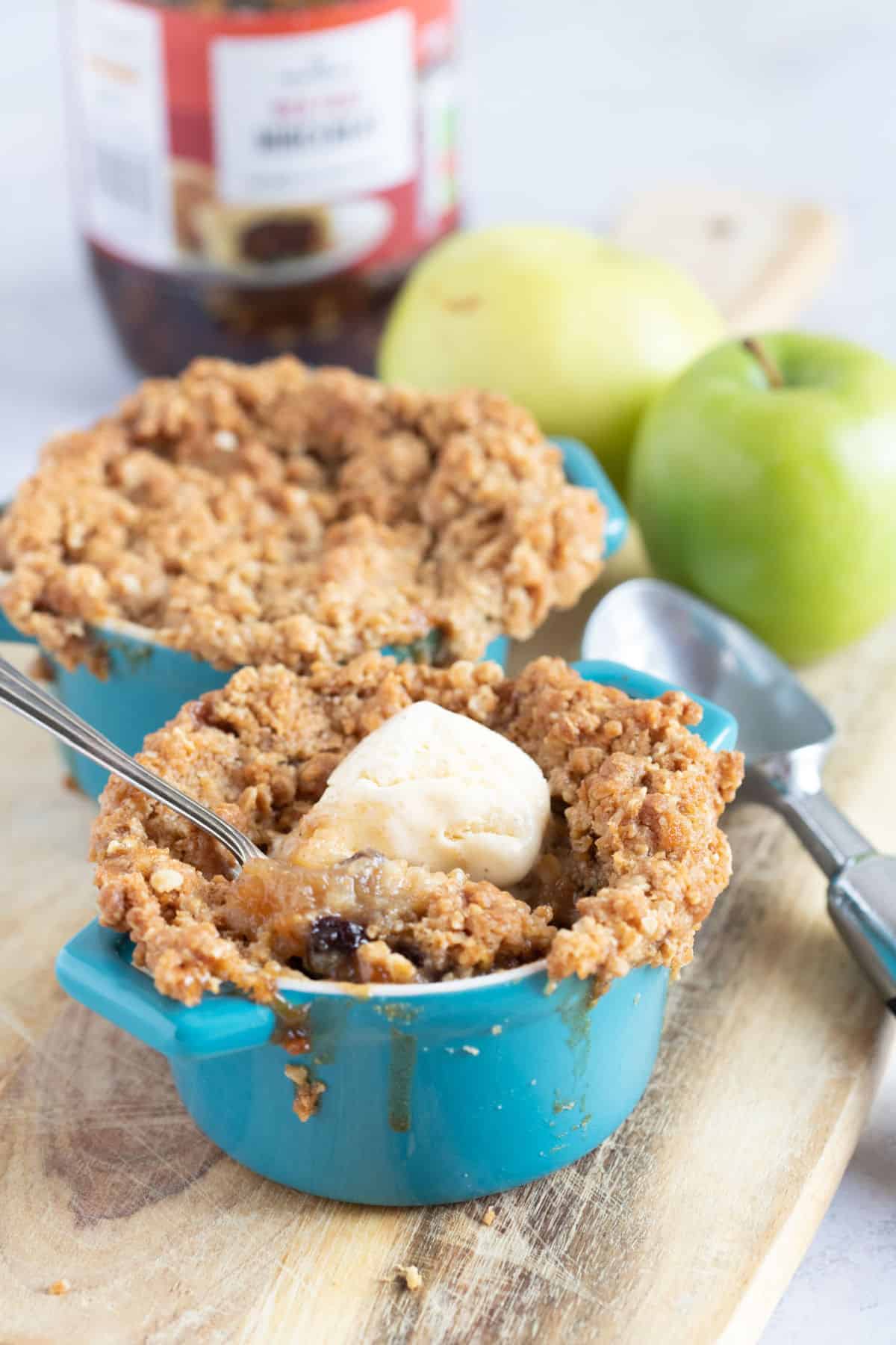 Apple and mincemeat crumble in individual pie dishes.