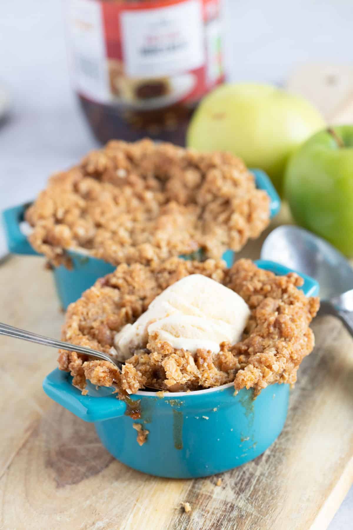 Apple and mincemeat crumble in individual pie dishes.