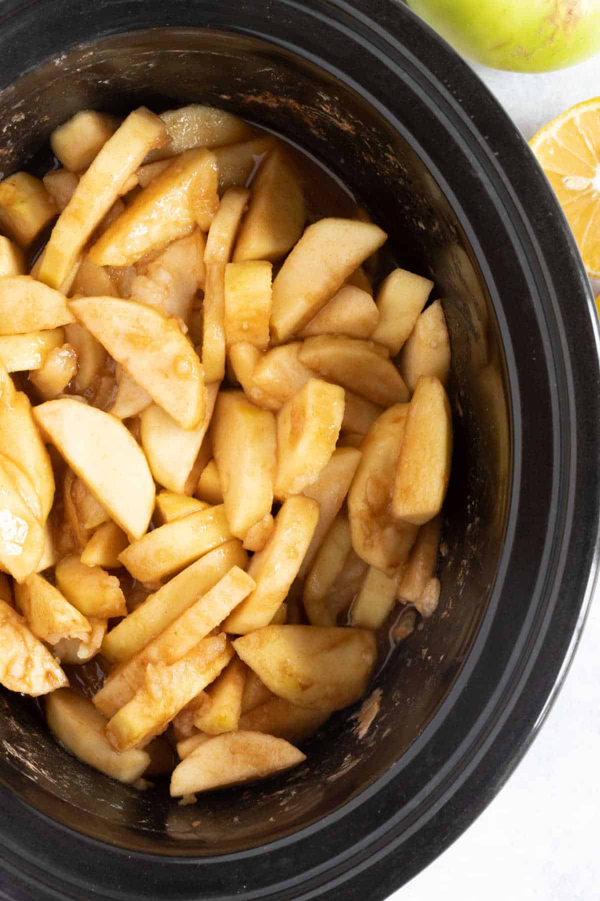 Slow cooker stewed apples in a black slow cooker.