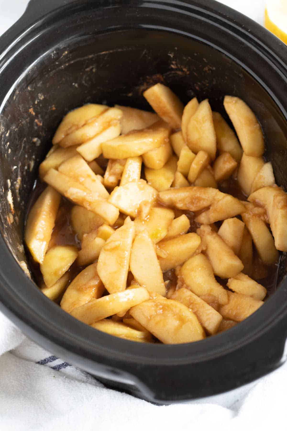 Stewed apples in a slow cooker basin.