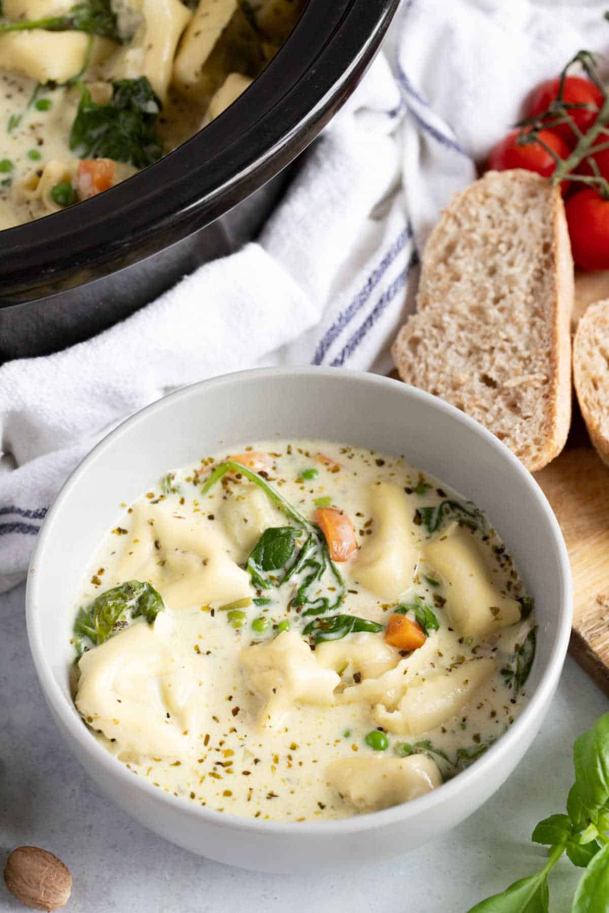 A bowl of creamy tortellini soup made in the slow cooker.