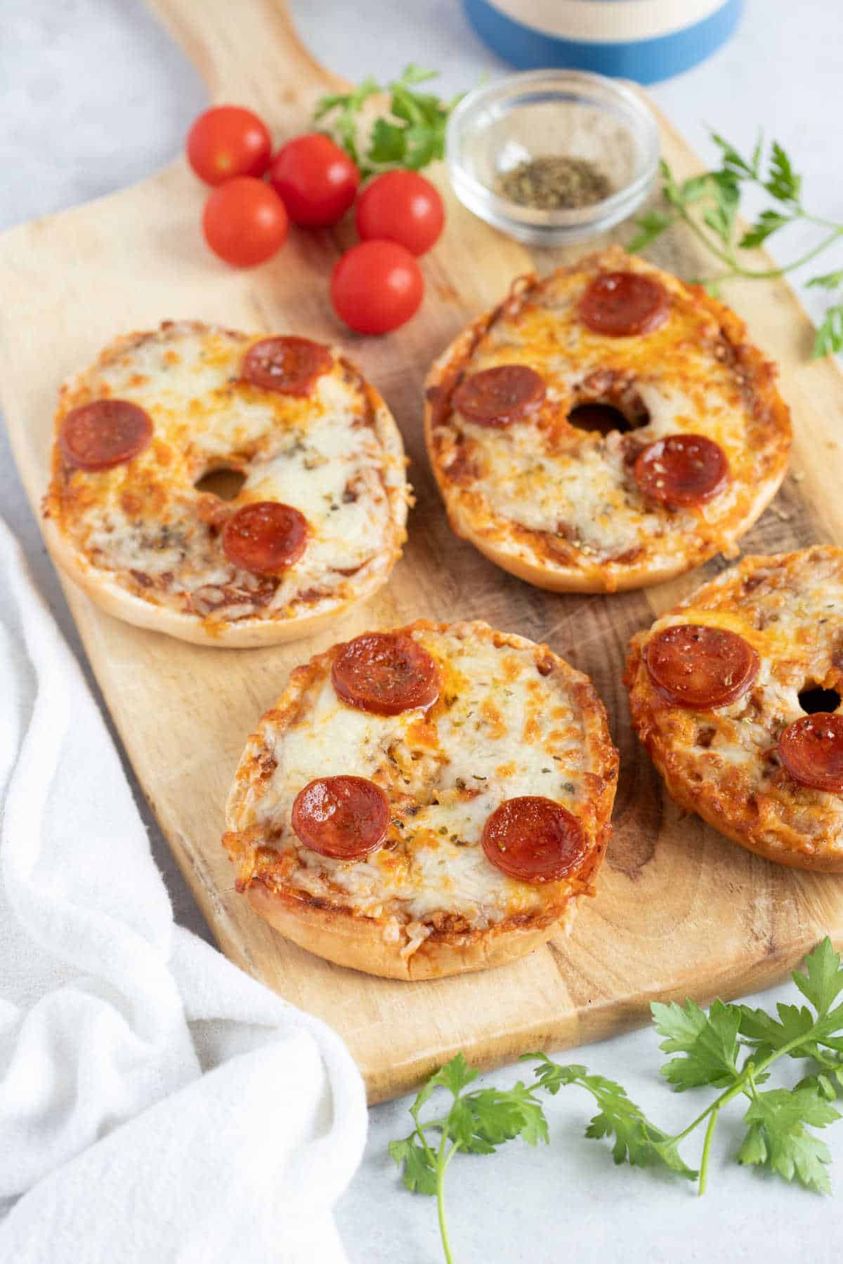 Pizza bagels on a serving board.