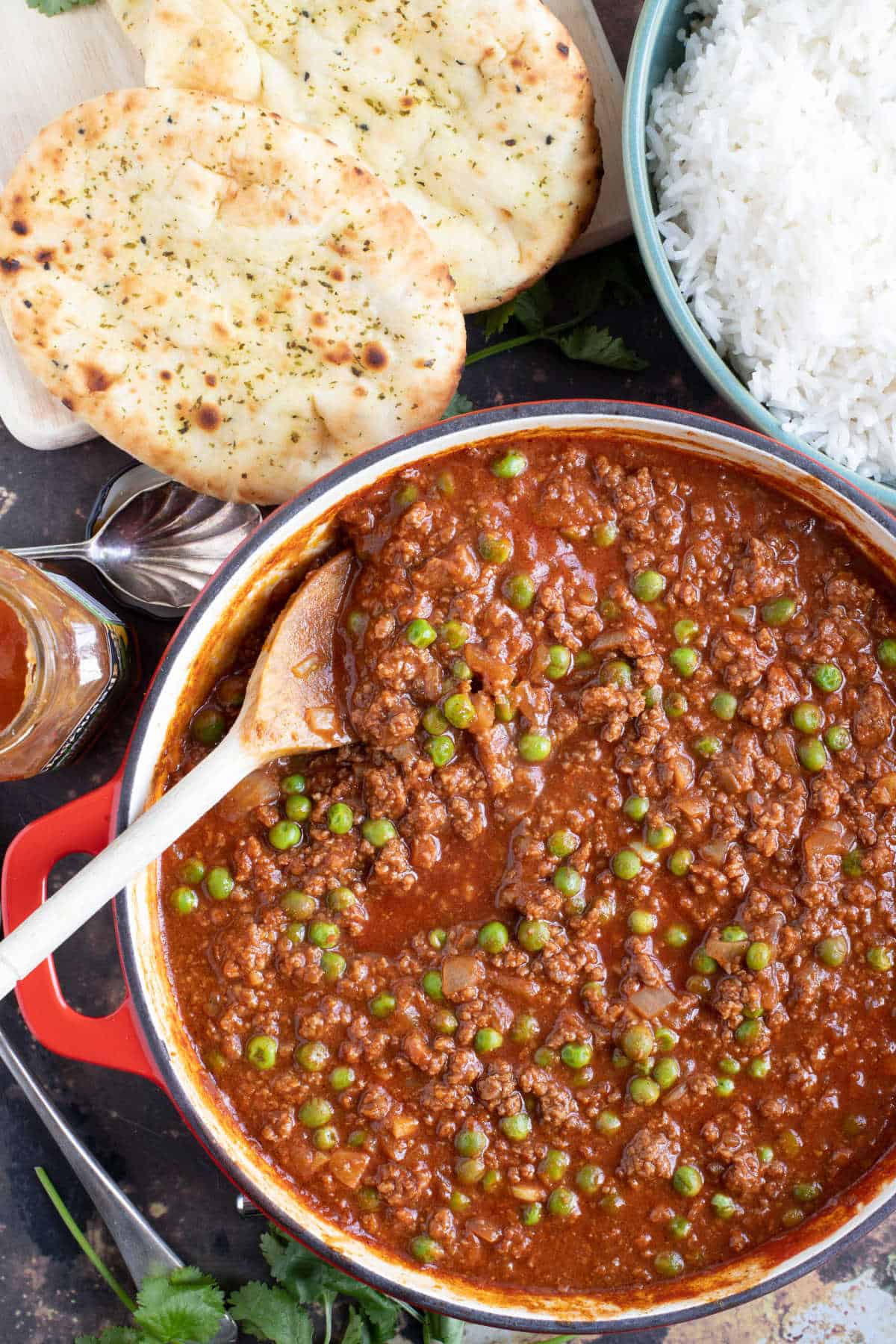 A pan of keema curry with rice and naan.