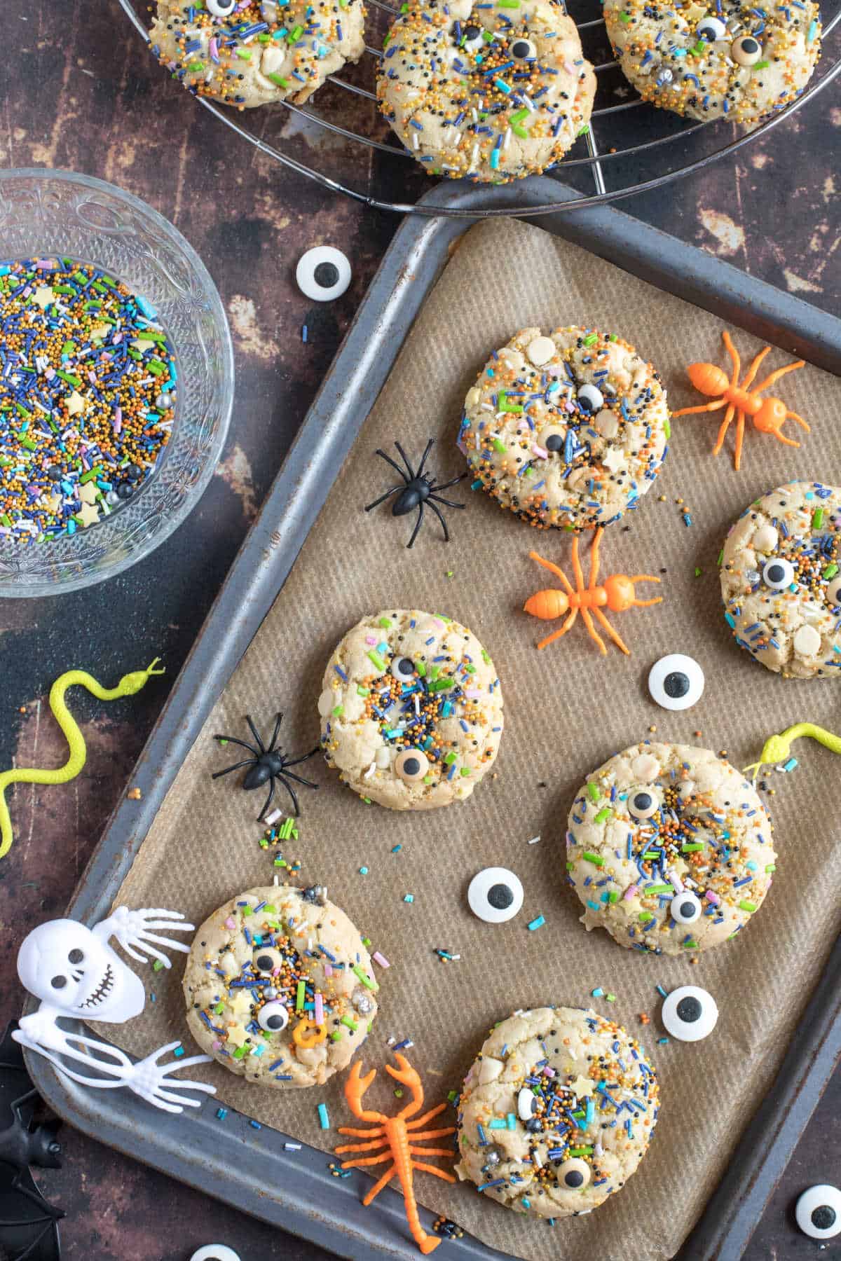 Halloween sprinkle cookies on a baking tray.