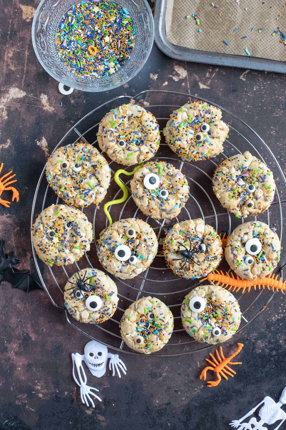 Halloween sprinkle cookies on a wire rack.