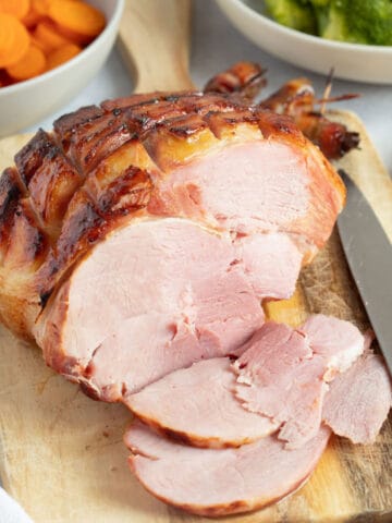 Slow cooker gammon in pineapple with a glistening honey glaze on top.