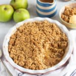 Sticky toffee apple crumble in a red pie dish.
