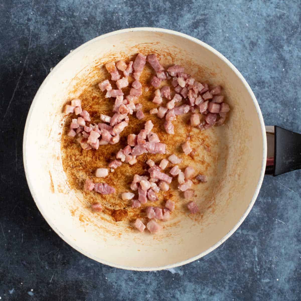 Bacon frying in oil.