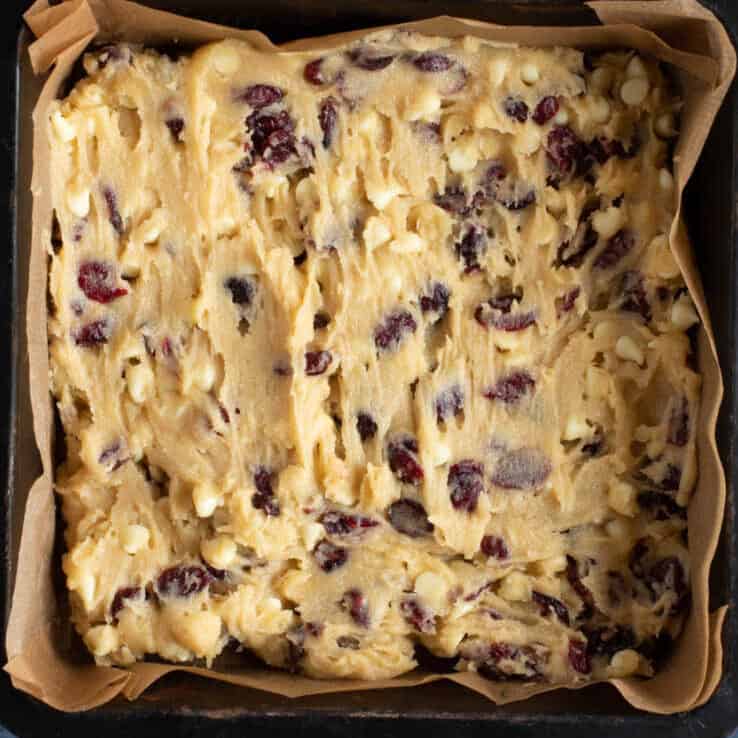 White chocolate cranberry blondie batter in a baking tin.