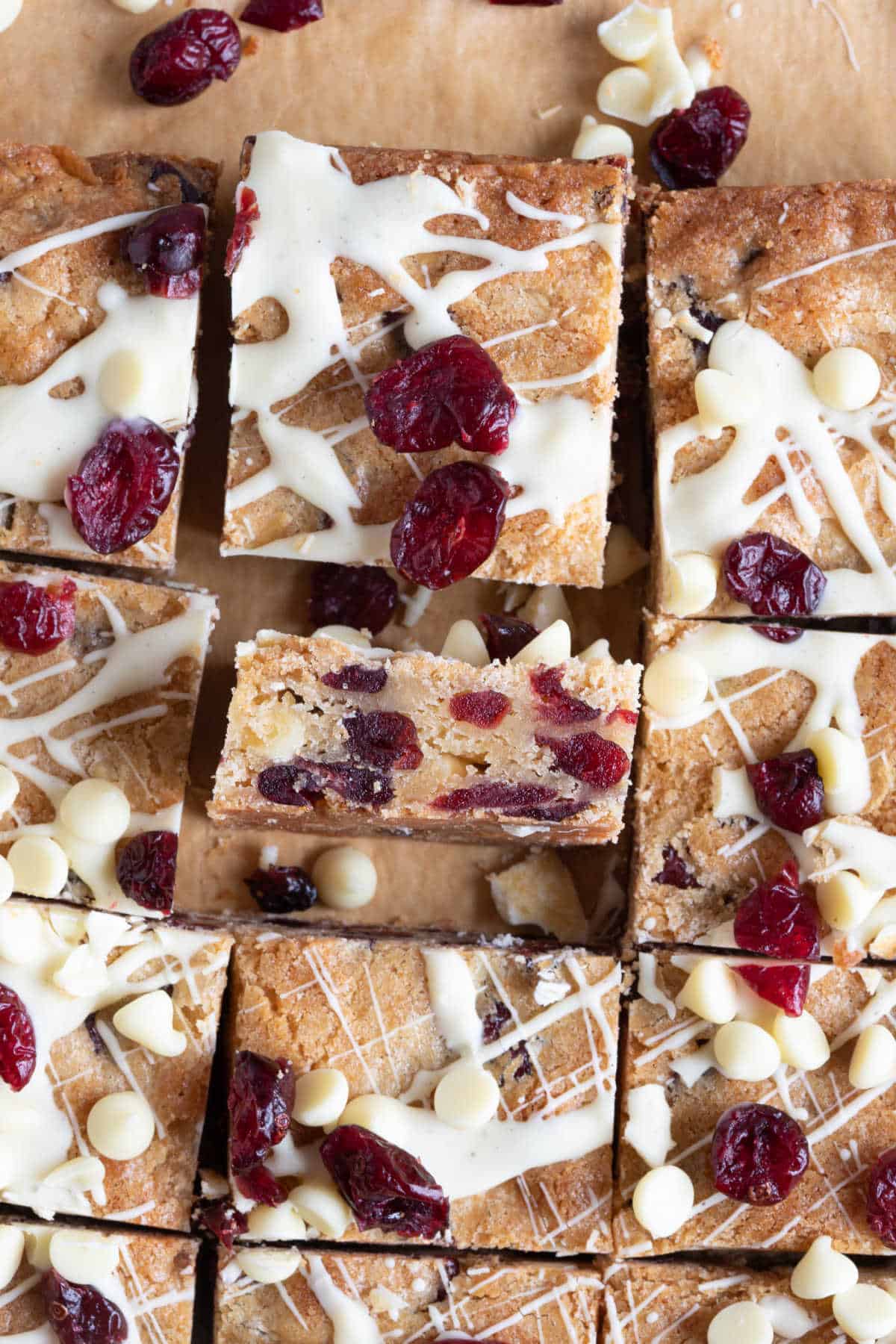 White chocolate cranberry blondies cut into bars with one facing up to show the texture of the bar.