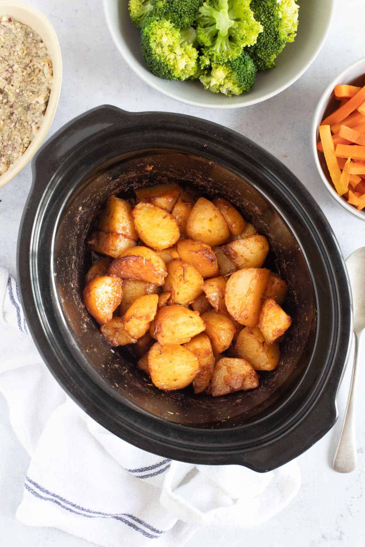 Roast potatoes in a slow cooker basin.