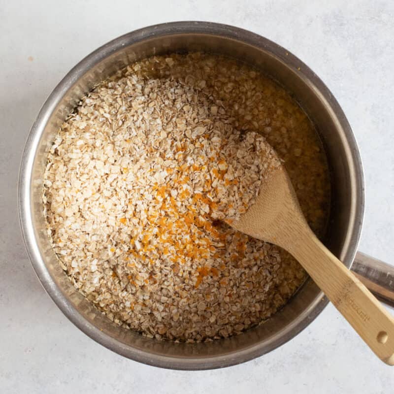 Oats and orange zest in a pan.