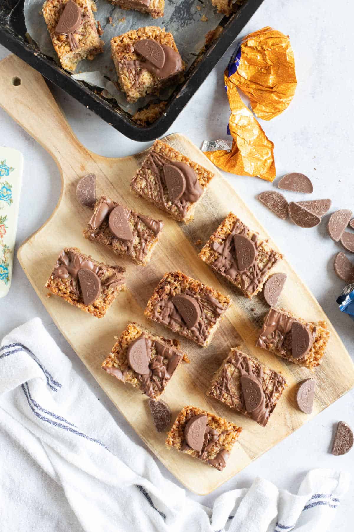 Chocolate orange flapjack bars on a wooden serving board.