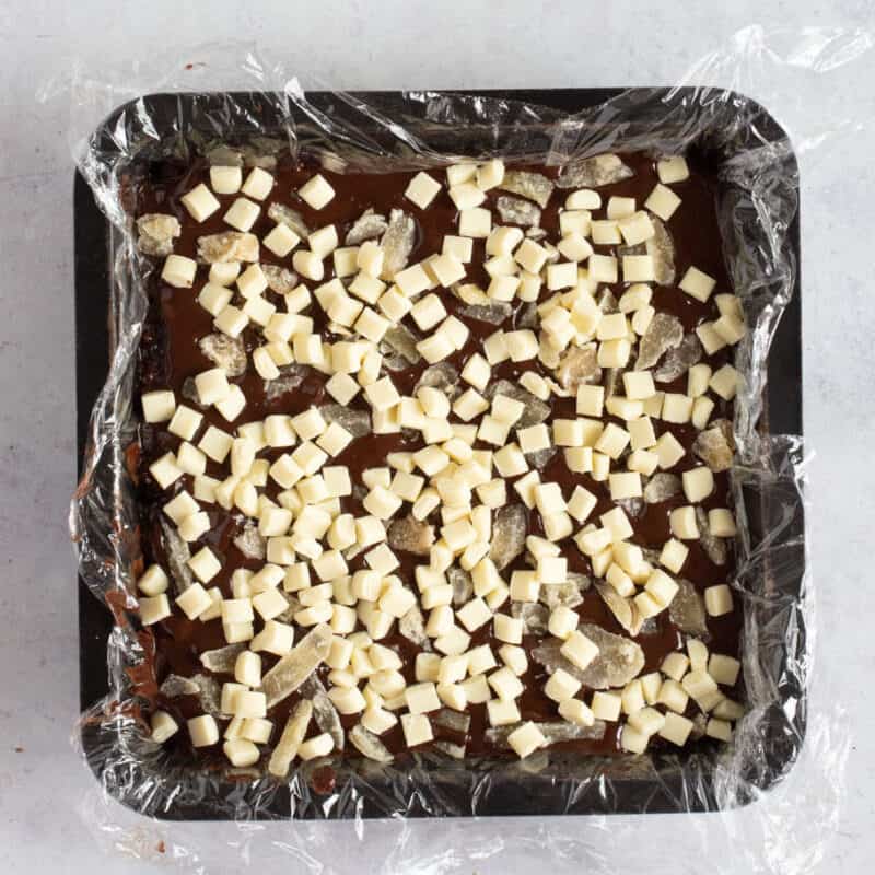 Dark chocolate tiffin in a baking tin.