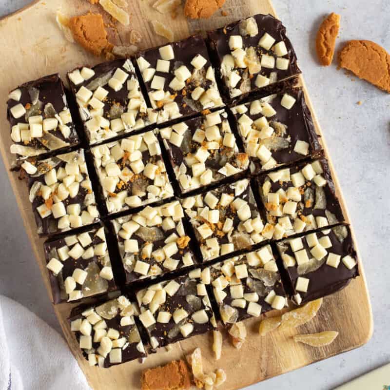 Dark chocolate tiffin with ginger on a wooden board.