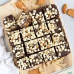 Dark chocolate tiffin bars on a wooden board.