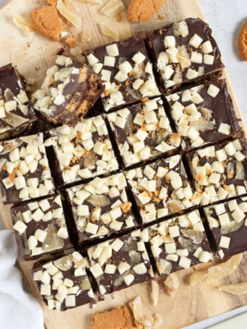 Dark chocolate tiffin bars on a wooden board.