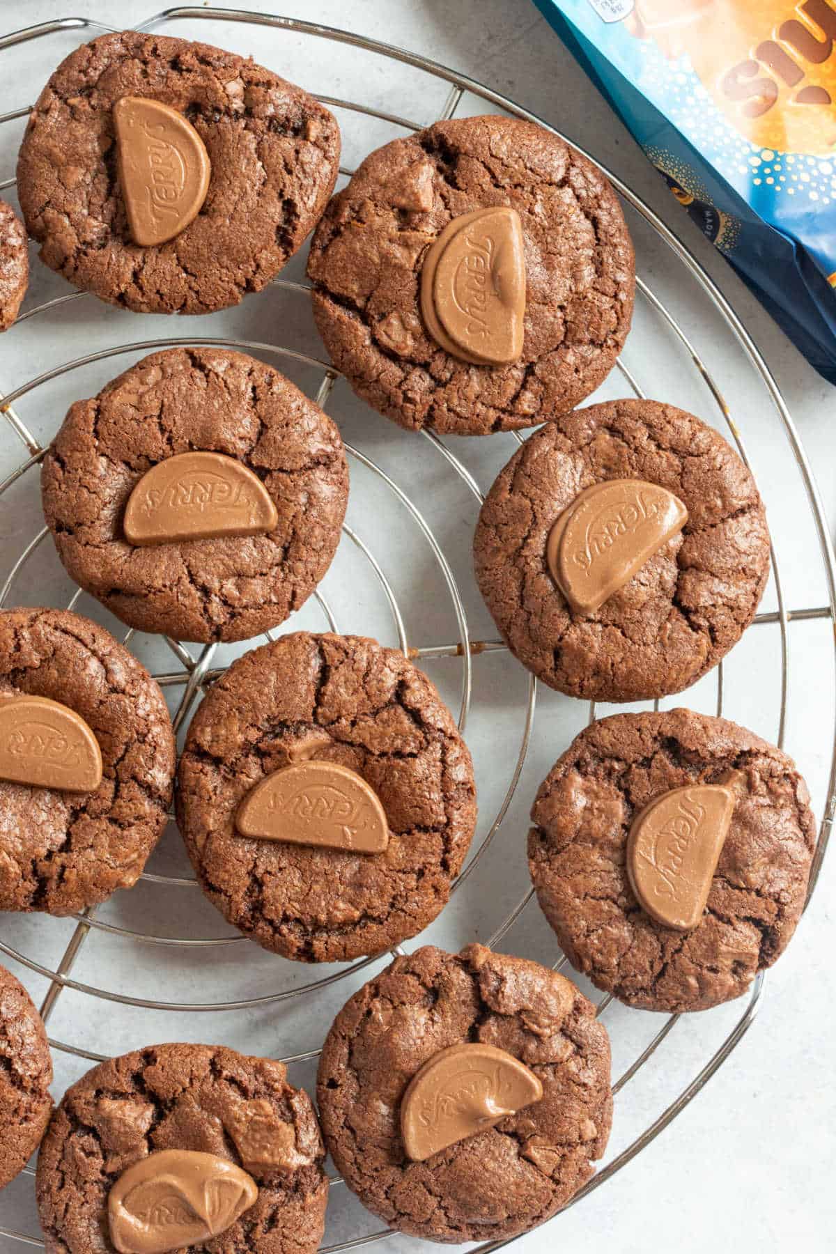 Chocolate orange cookies on a cooling rack.