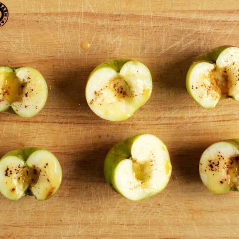 Cut apples on  wooden board.