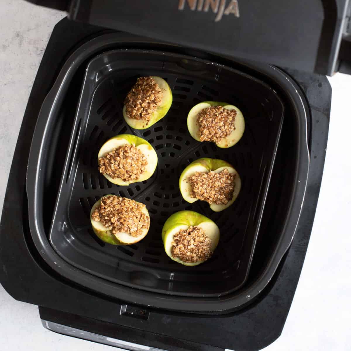 Baked apples in air fryer basket.