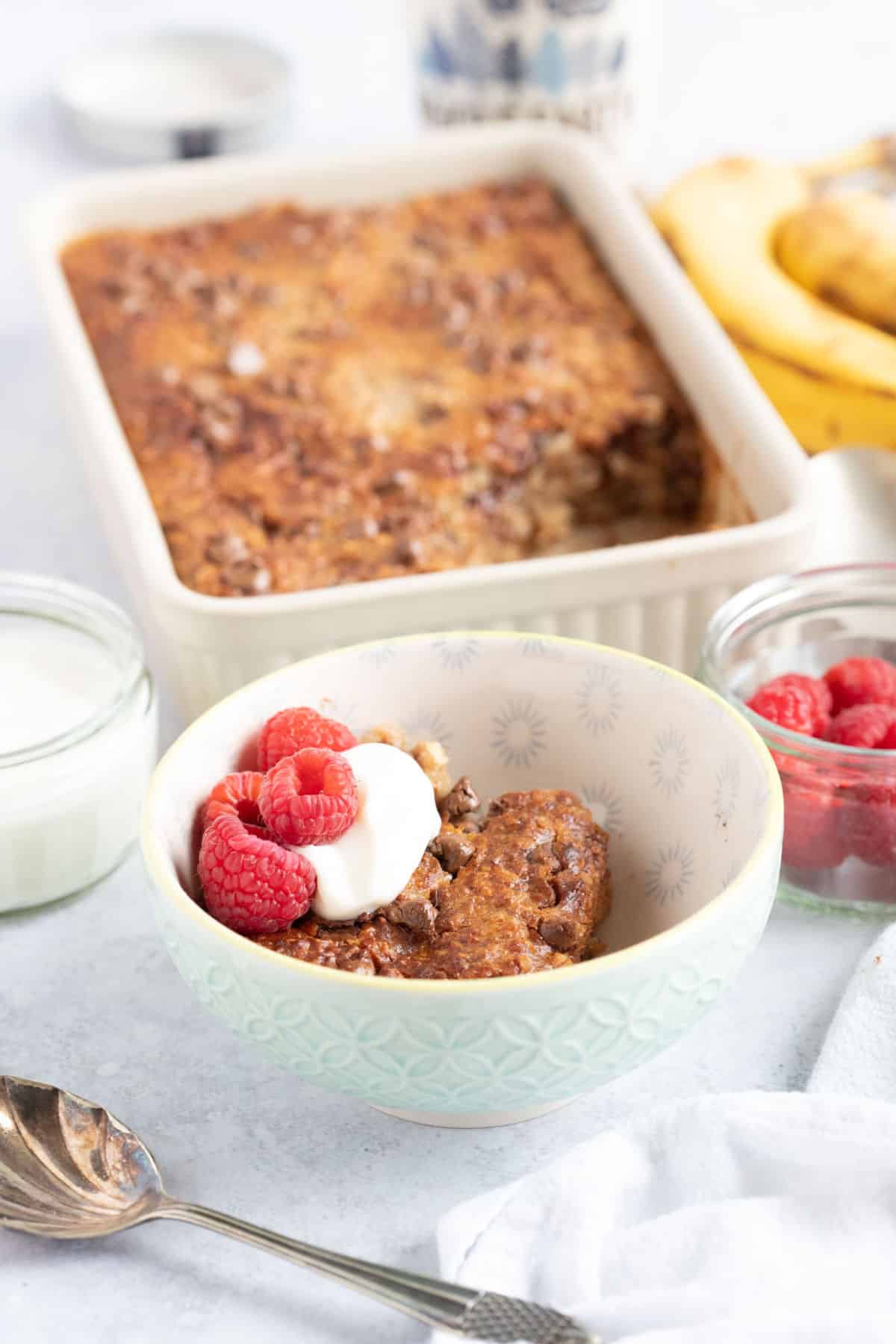 A bowl of air fryer baked oats with berries and yogurt.