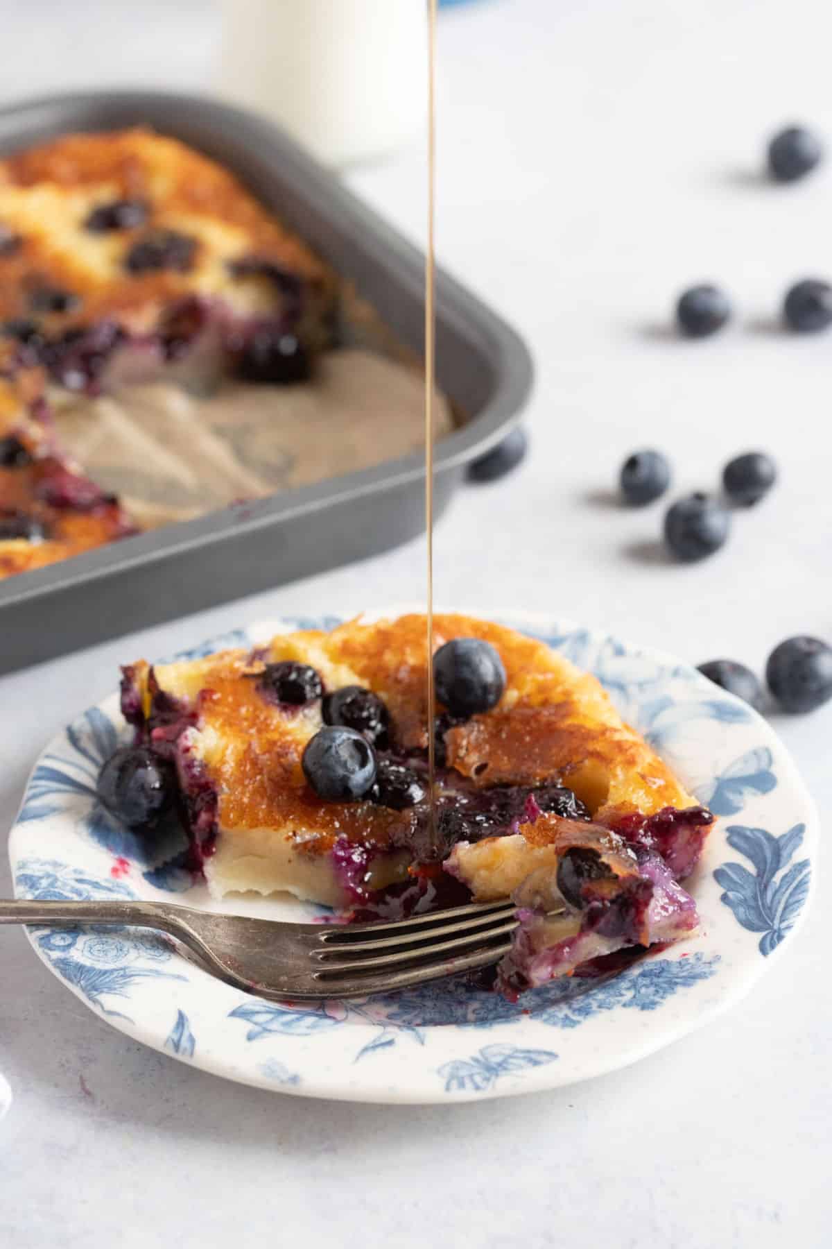 An air fryer blueberry pancake drizzled with maple syrup.