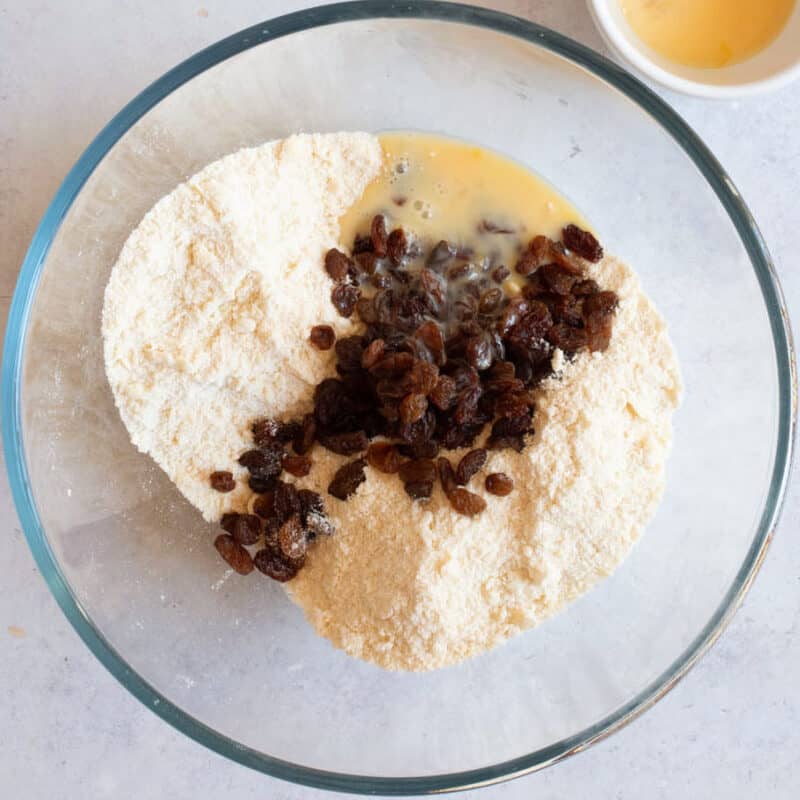 Adding egg to the rock cakes dough.