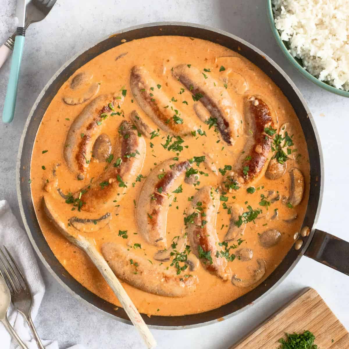 Sausage strognaoff garnished with parsley.