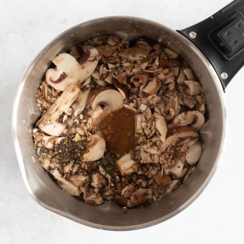 Mushrooms and stock in a soup maker.