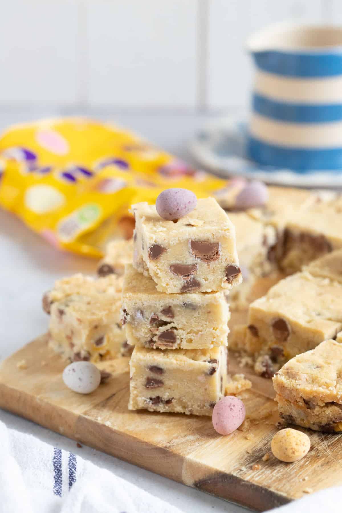 A stack of air fryer mini egg shortbread on a wooden board.