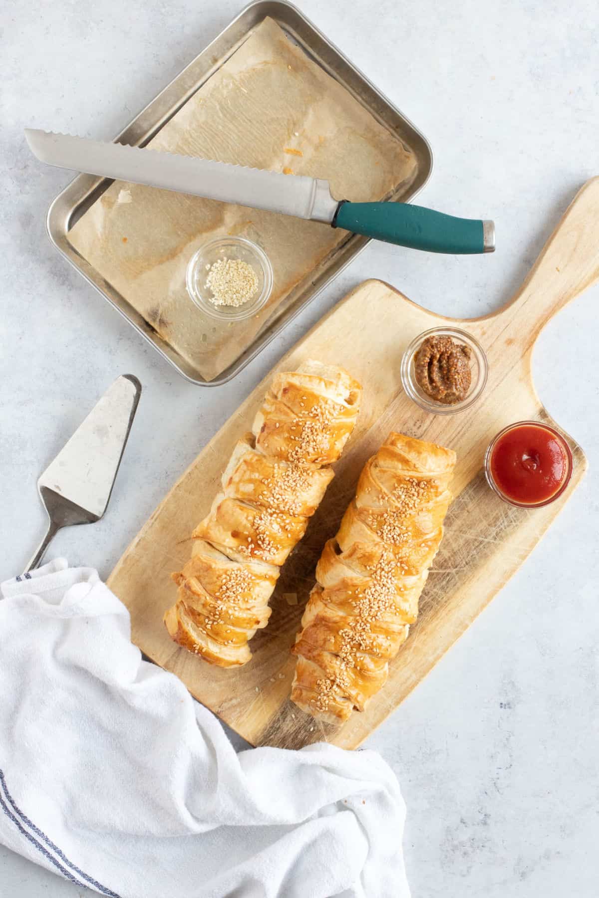 Sausage plaits on a wooden board.