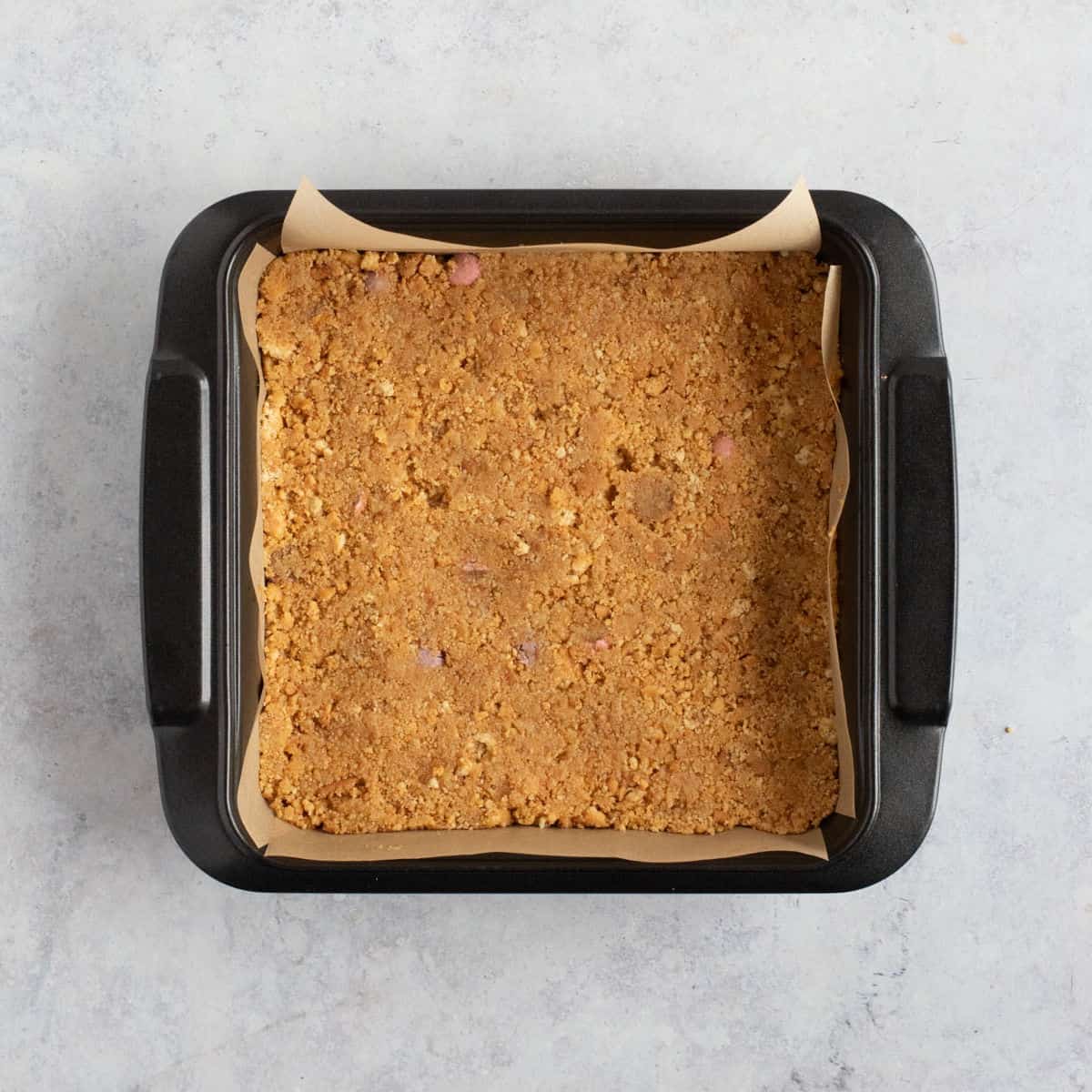 Digestive base in a baking tin.